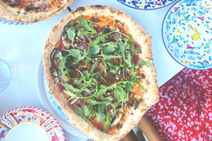 Wood-fired restaurant pizza with arugula.