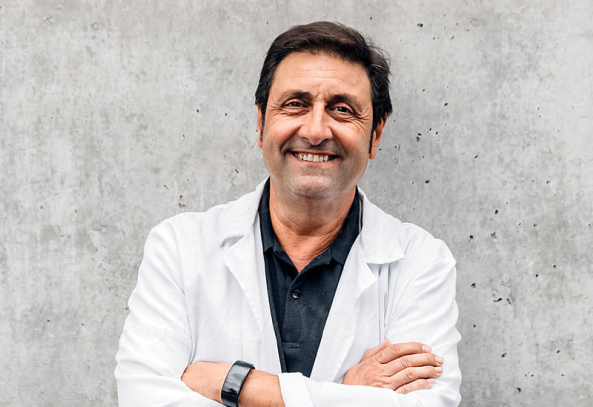 Smiling male doctor in white coat. 